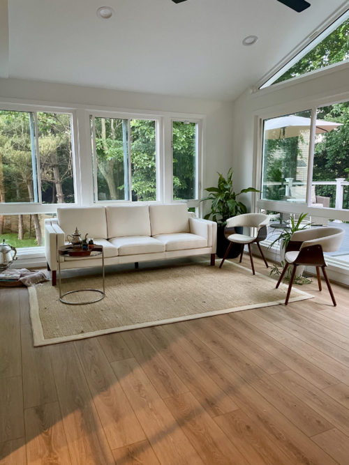 Modern living room with a white sofa and chairs